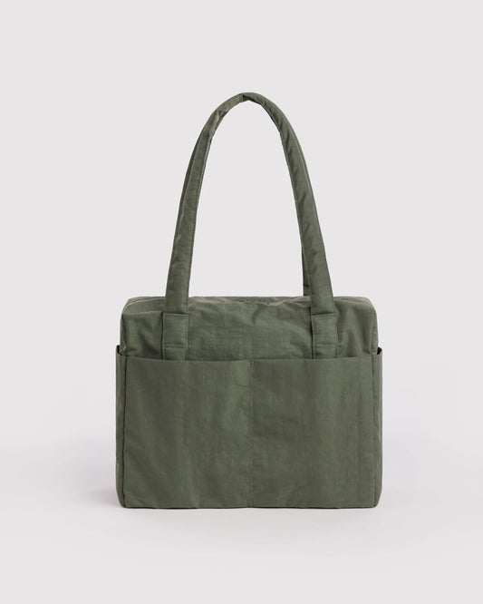 An olive green fabric travel tote bag with two shoulder straps and front pockets, shown against a plain light gray background.