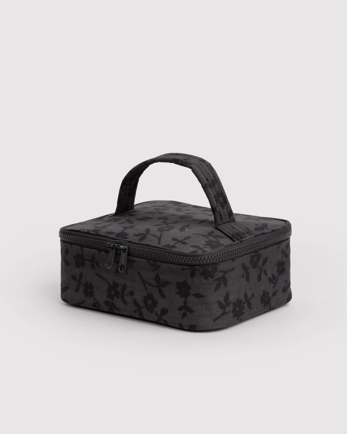 Black floral-patterned travel case on a light gray background