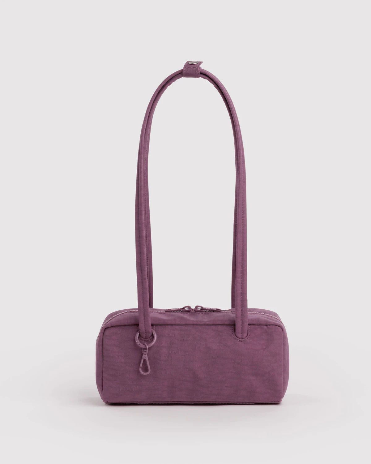 BAGGU Small Nylon Bowler Bag in Wild Plum colour on a grey background 