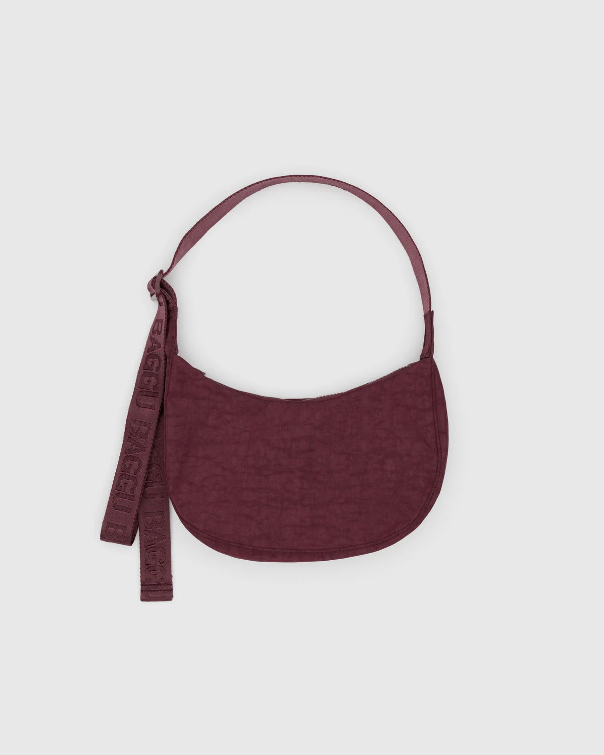 Maroon handbag with a strap on a light gray background