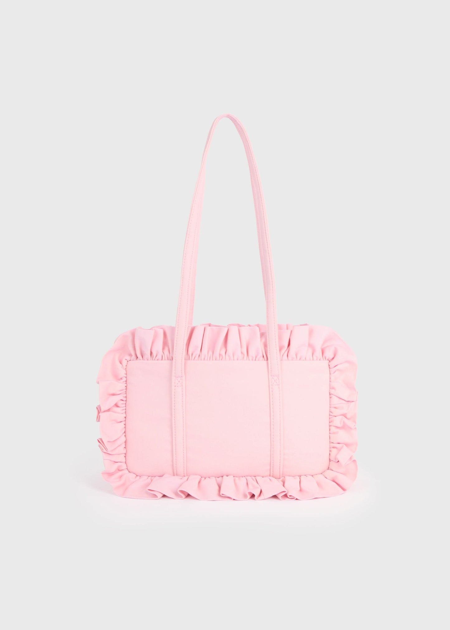 Pink handbag with ruffled details on a light gray background