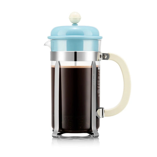 French press with a light blue lid and white handle on a white background