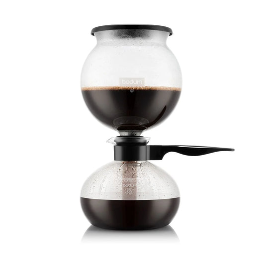 Siphon coffee apparatus with coffee brewing inside on a white background
