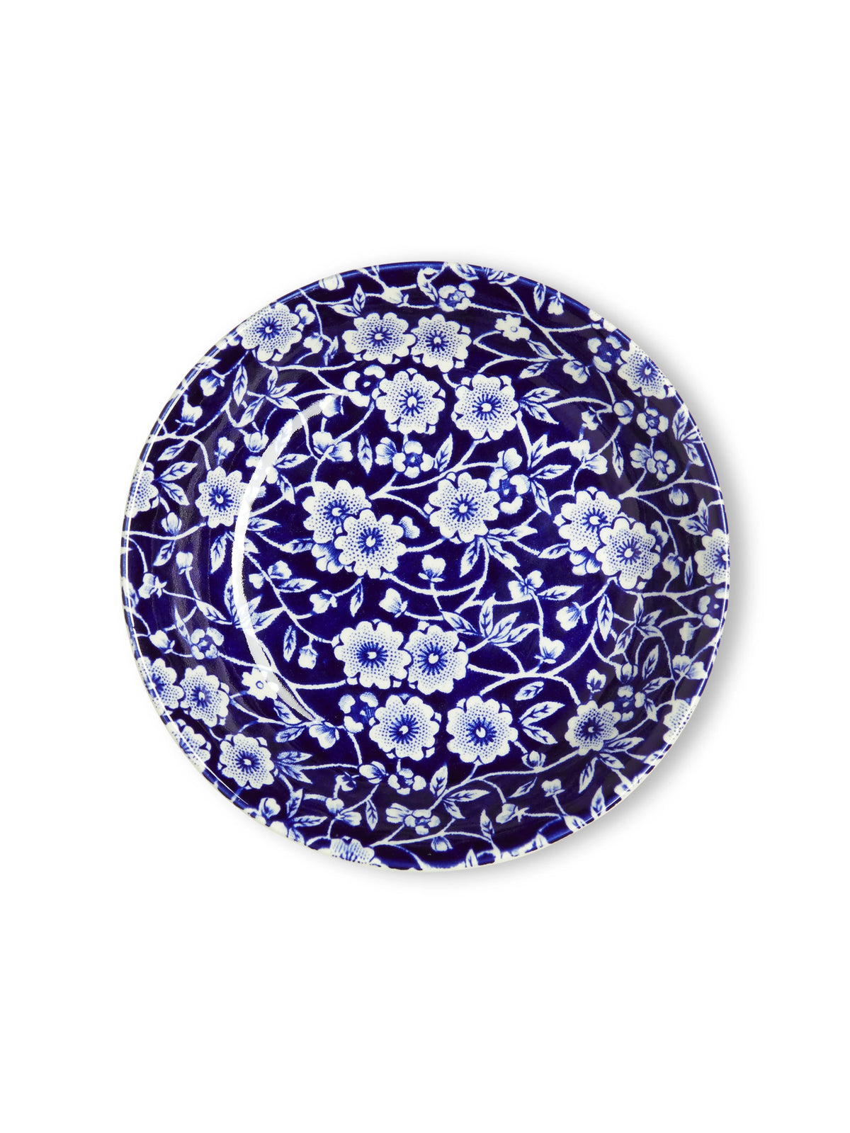 A round ceramic plate featuring an intricate cobalt blue and white floral pattern, photographed from directly above on a clean white background.