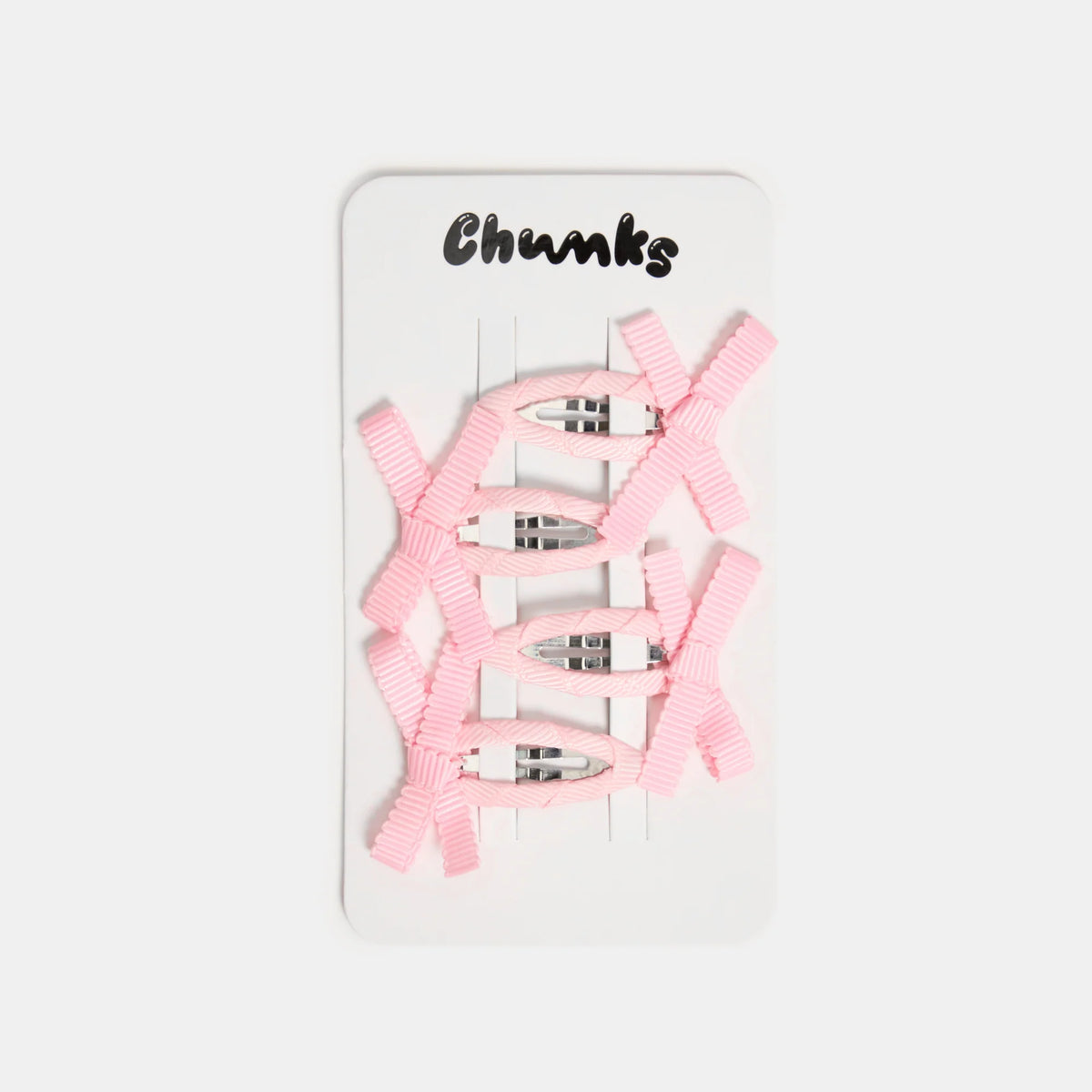 Six pink ribbon hair clips arranged on a white display card with the brand name 'Chunks' printed at the top, set against a light gray background.