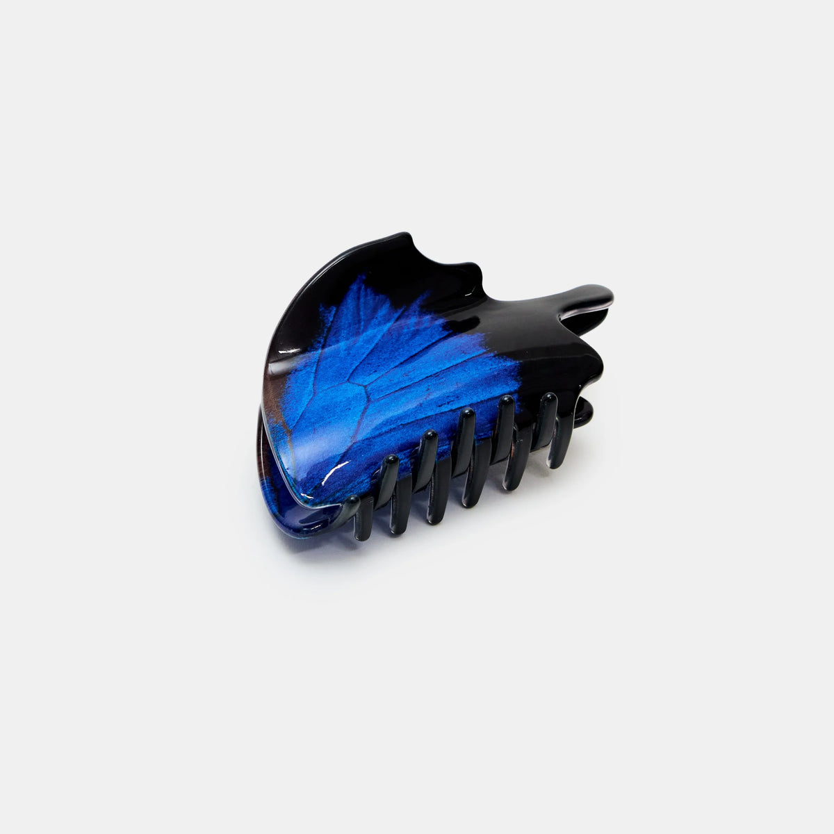 Black butterfly hair clip with blue marbled design on a white background