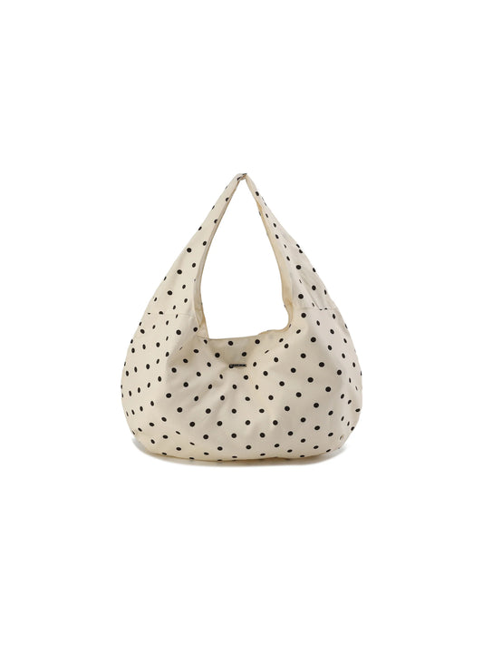 Beige handbag with black polka dots on a white background
