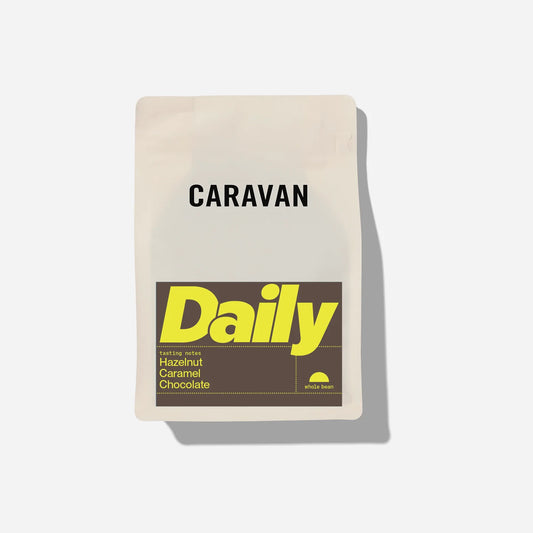 Caravan Daily coffee packaging on a light gray background