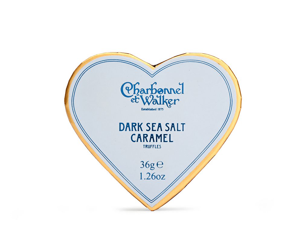 Box of truffles in a blue heart shaped box on a white background 