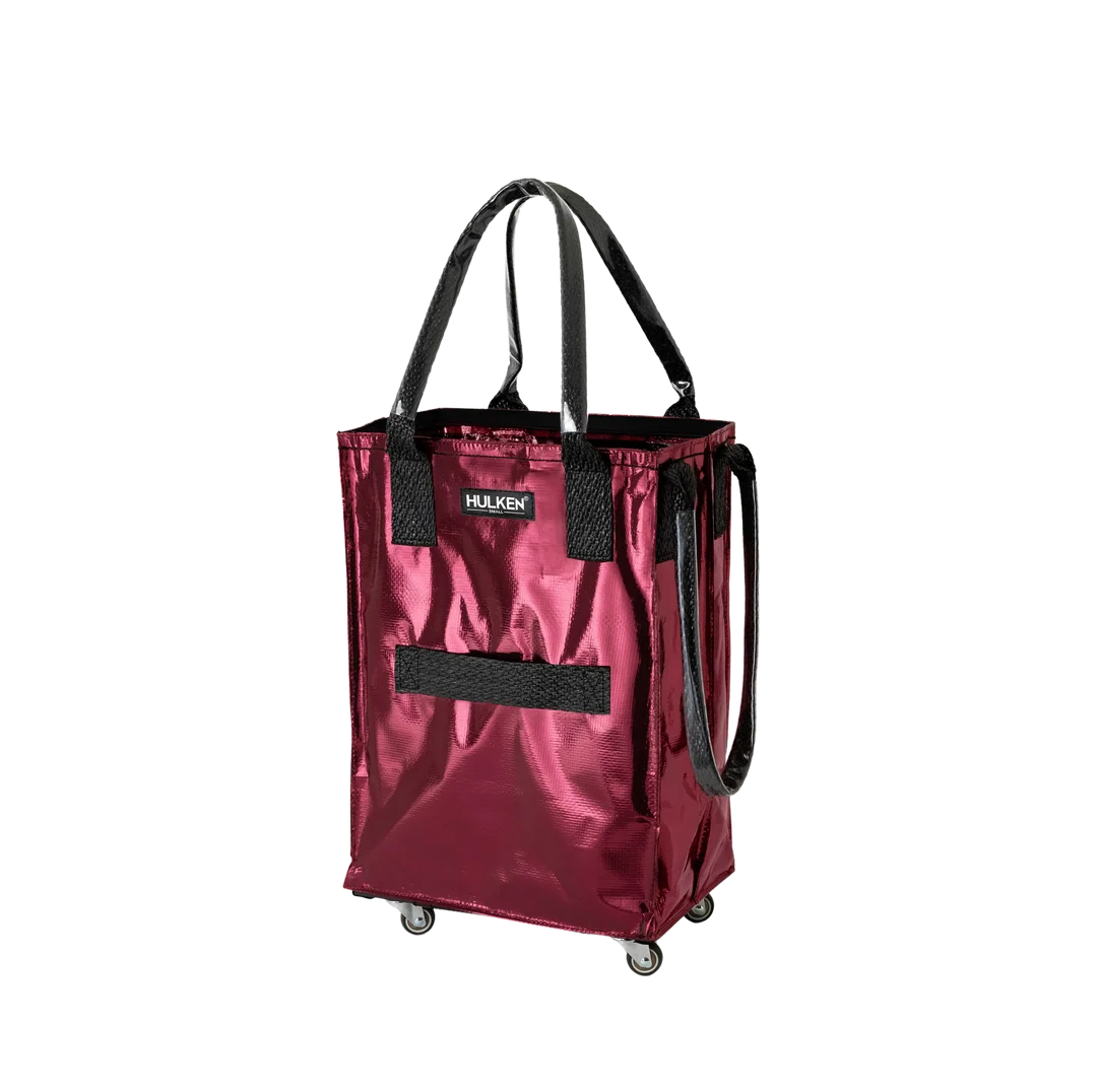 A metallic burgundy shopping tote bag with black handles, black mesh accents, and caster wheels, shown on a plain white background.