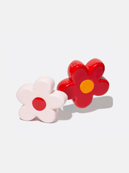 Ceramic pink and red daisy flower shaped salt and pepper shakers on white background