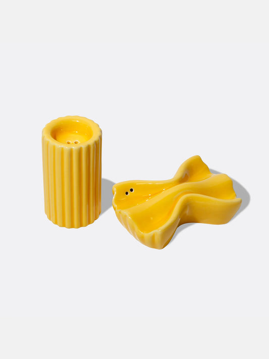 Two yellow ceramic pasta-shaped salt and pepper shakers on a white background