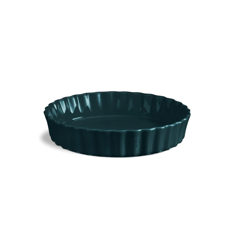 Deep navy ceramic tart dish on a white background