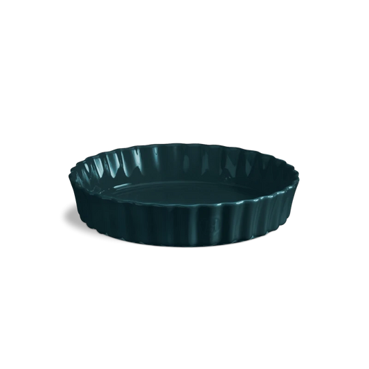 Deep navy ceramic tart dish on a white background