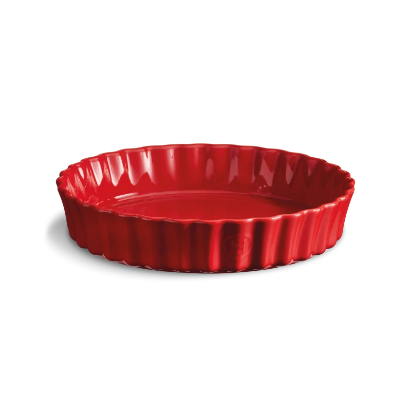 Red ceramic fluted pie dish on a white background