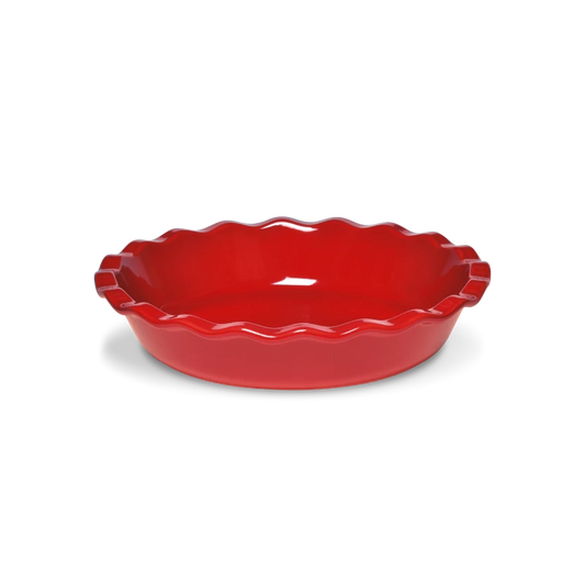 Red ceramic pie dish with scalloped edge on a white background