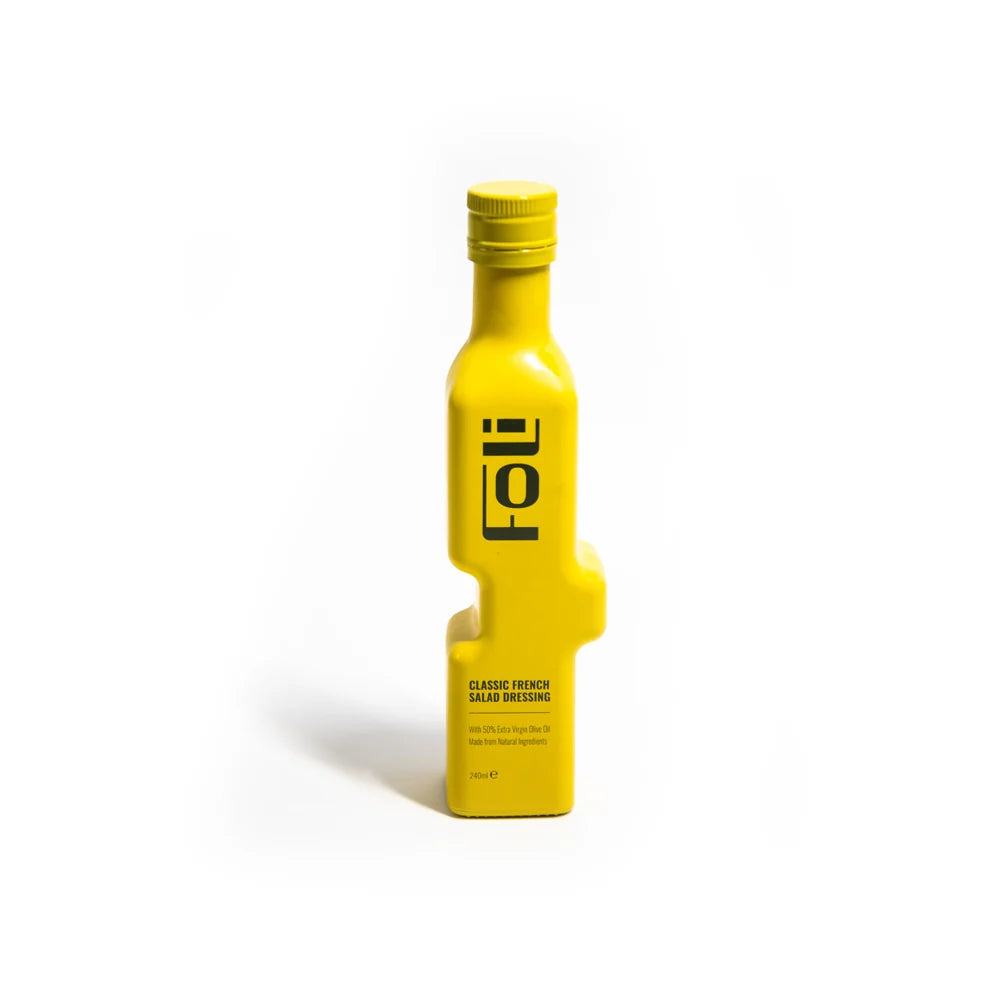 A bright yellow Folio Classic French Salad Dressing bottle with a matching yellow cap, standing upright on a clean white background.