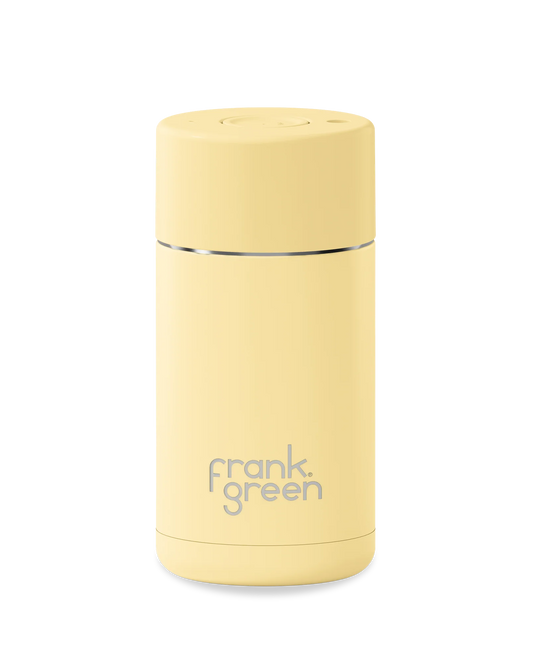 A pale yellow Frank Green vacuum insulated travel bottle with a matching screw-on lid, shown on a solid white background.