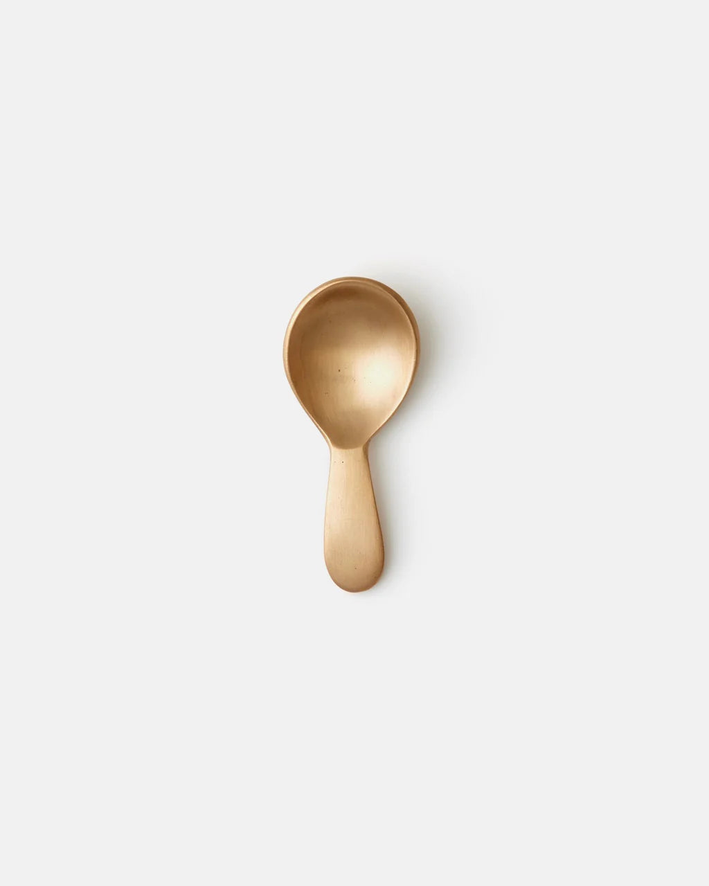 Gold spoon on a white background