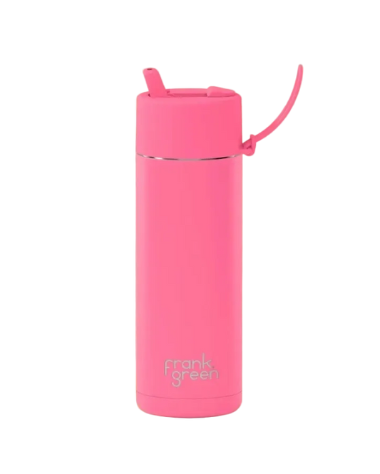 A bright pink vacuum-insulated tumbler with a matching pink lid and carrying loop, featuring the 'frank green' logo near the bottom, set against a solid pale yellow background.