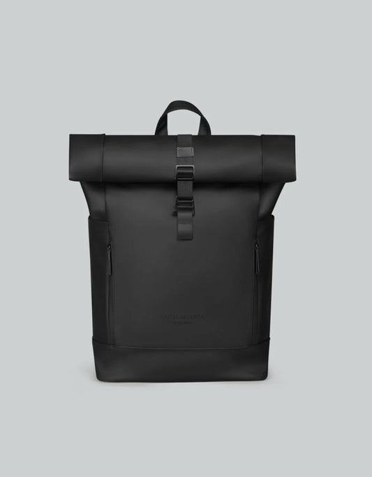 Black roll-top backpack on a light gray background