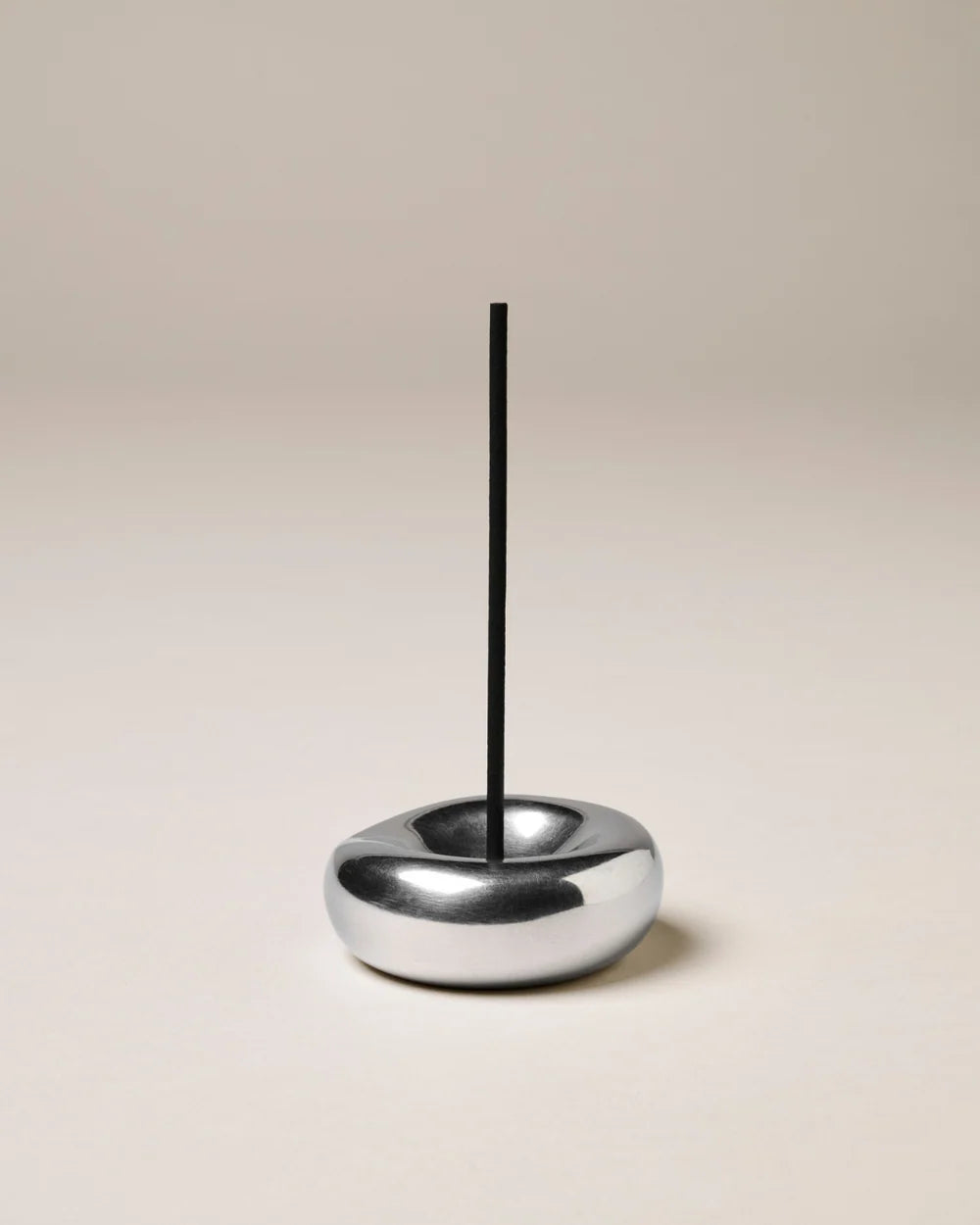 Gentle Habits Chrome Incense Holder on a beige background 