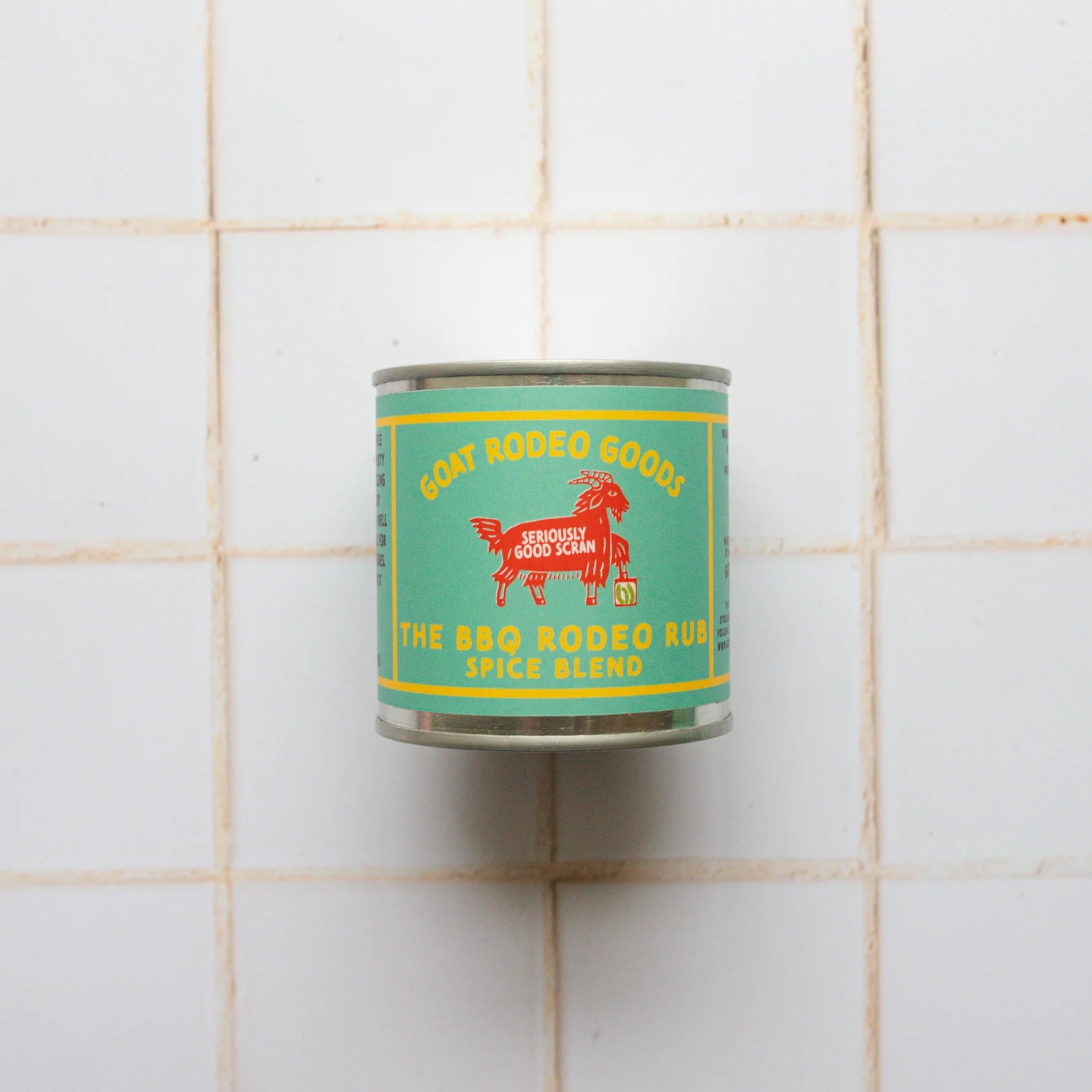 Can of 'The BBQ Rodeo Rust Spice Blend' on a tiled wall
