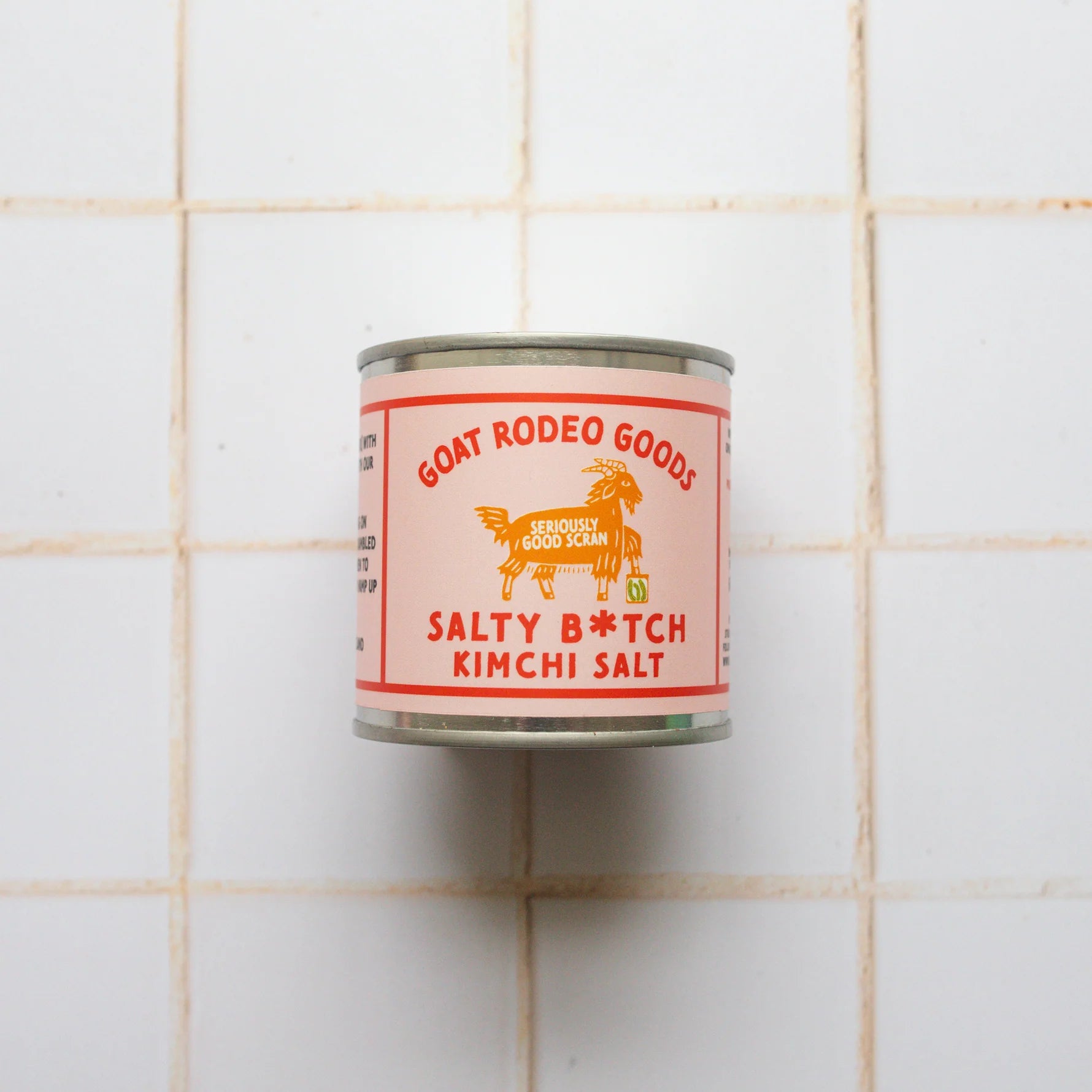 Can of Goat Rodeo Goods Salty B*tch Kimchi Salt on a tiled wall