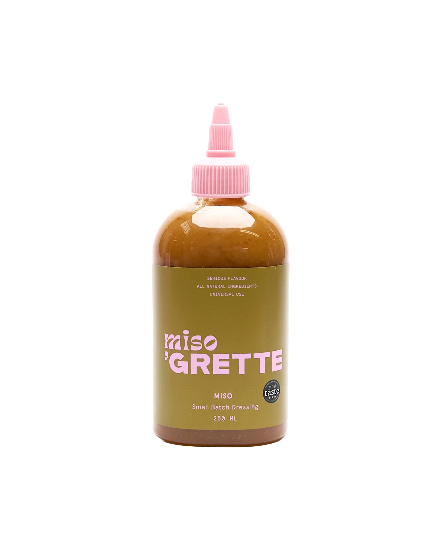 Bottle of Miso Grette dressing with a pink cap on a white background