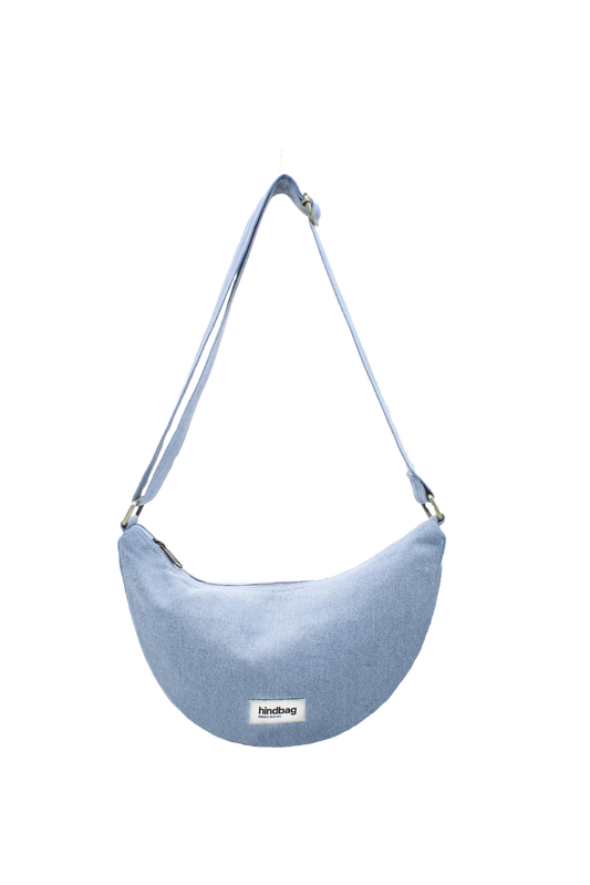 Blue denim crossbody bag on a white background