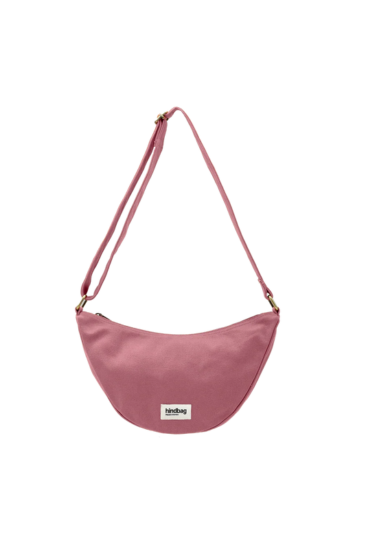 Pink cotton crossbody bag with a visible brand label on a white background