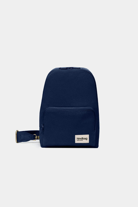 Navy blue backpack with a visible brand label on a light gray background
