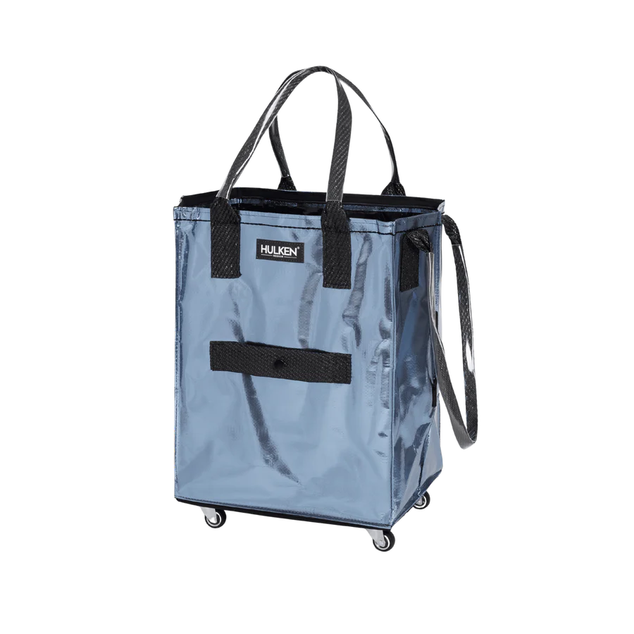 A Harken blue shopping tote bag with black handles, a black front strap, and black wheels, shown on a plain white background.