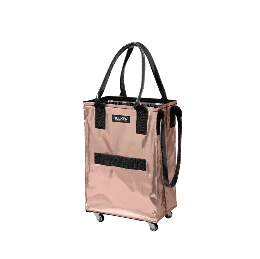 A metallic rose gold rolling utility tote bag with black handles, a black front hook-and-loop panel, and a visible HULKEN brand label, shown on a plain white background.