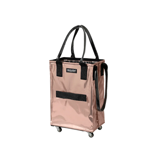 A metallic rose gold rolling utility tote bag with black handles, a black front hook-and-loop panel, and a visible HULKEN brand label, shown on a plain white background.