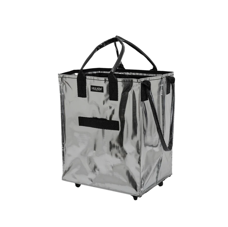 Silver shopping cart with black handles on a white background