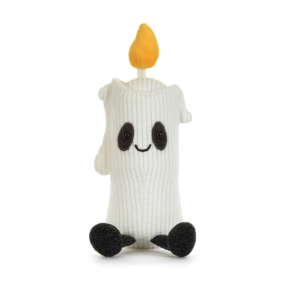 A white ribbed knit plush candle toy with a yellow flame on top, black embroidered eyes and smile, and black feet, shown on a plain white background.