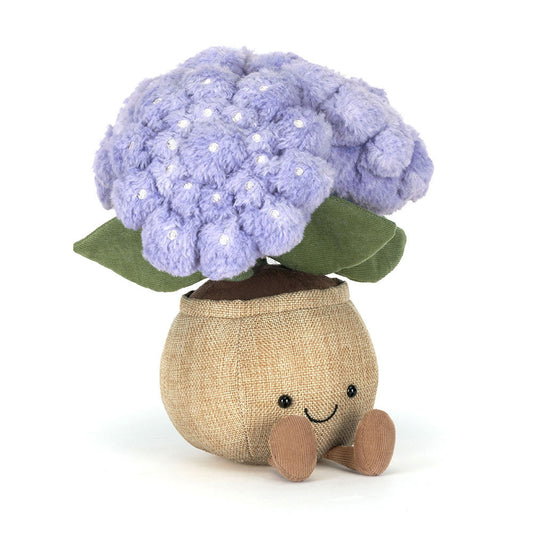 Plush toy resembling a hydrangea with a smiling face on a white background