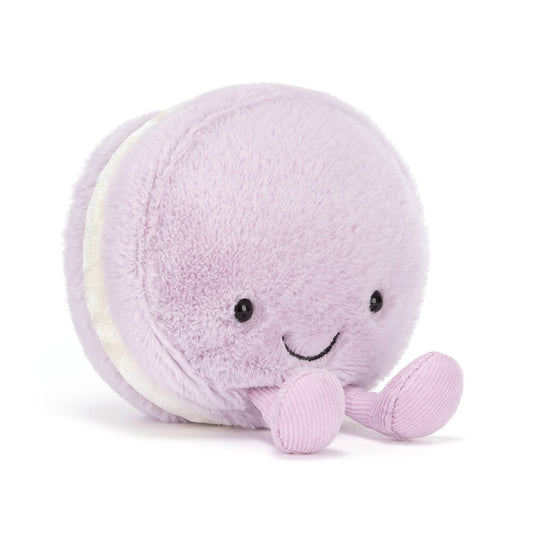 Purple plush toy with a smiling face on a white background