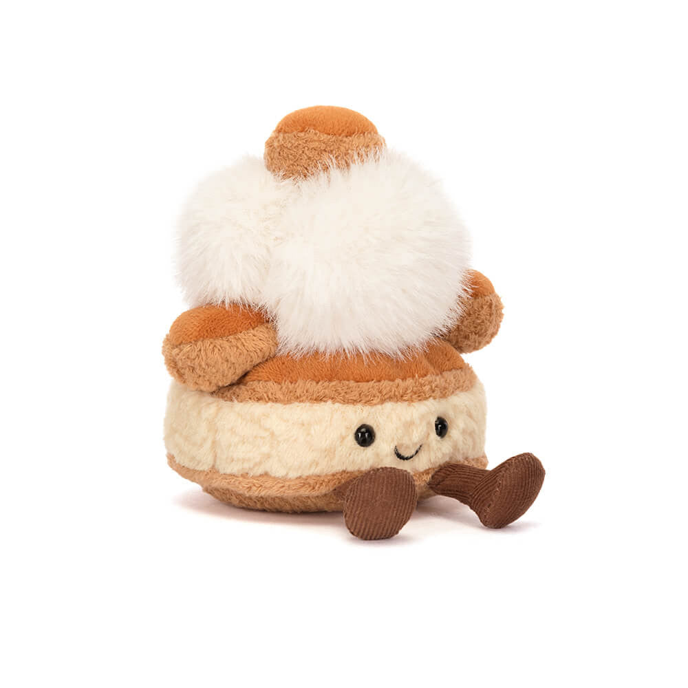 Plush toy resembling a French pastry mirielle with brown and white colors on a white background