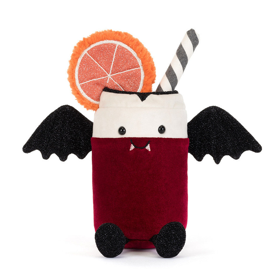 A plush vampire cocktail toy featuring a red body, black wings and feet, a white face section, a striped straw, and an orange slice garnish, set against a plain white background.