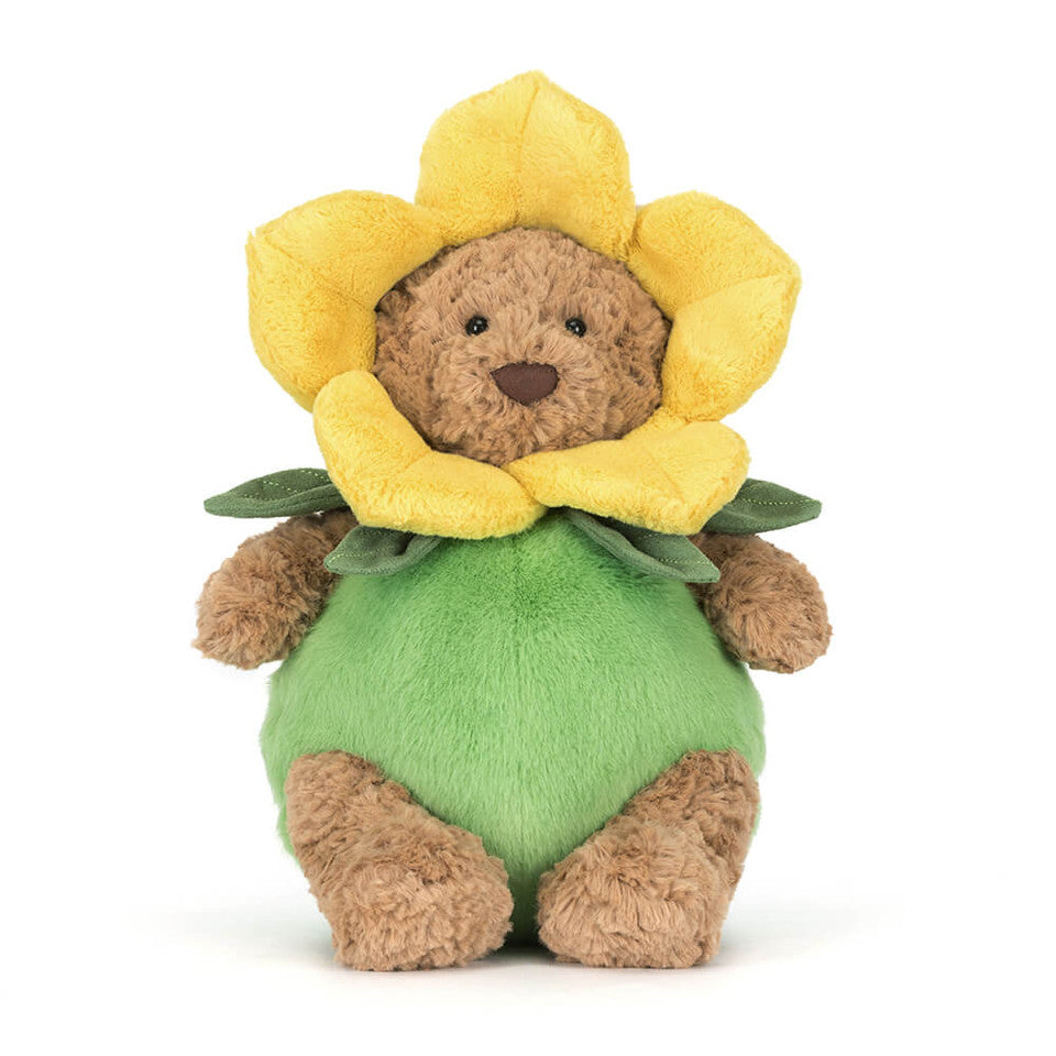 Stuffed toy bear with a yellow flower on a white background