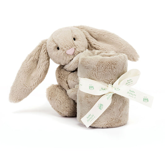 Plush bunny toy with a blanket wrapped around it on a white background