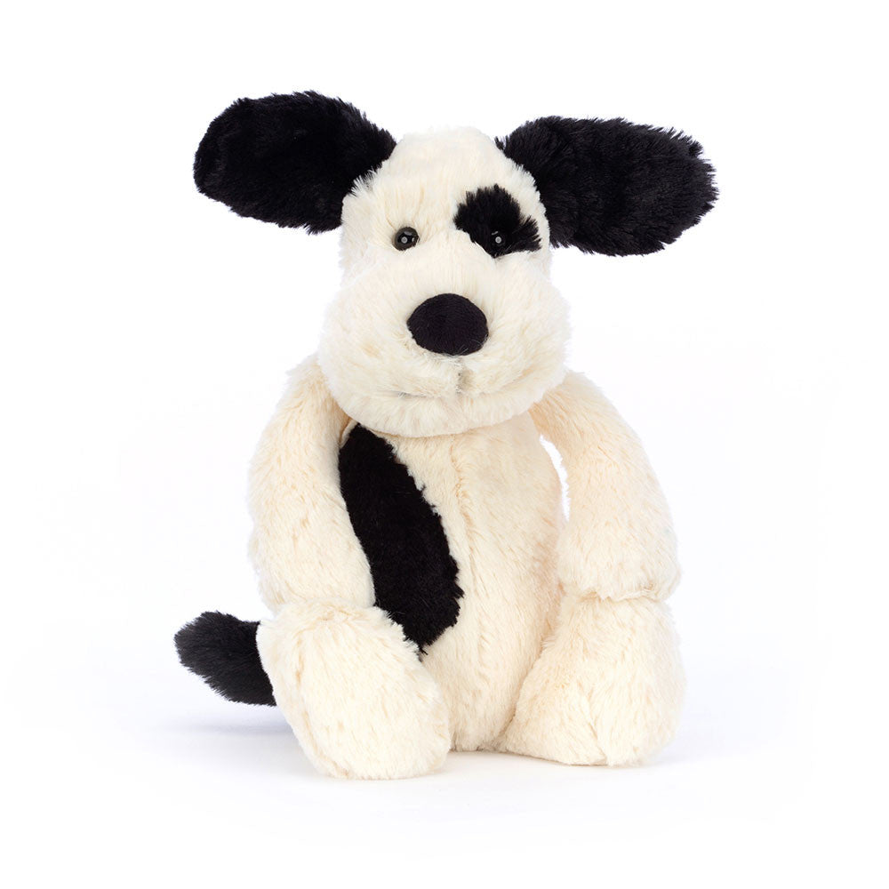 Black and white plush toy on a white background