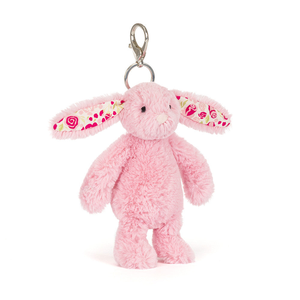 Pink plush bunny keychain with floral patterns on a white background