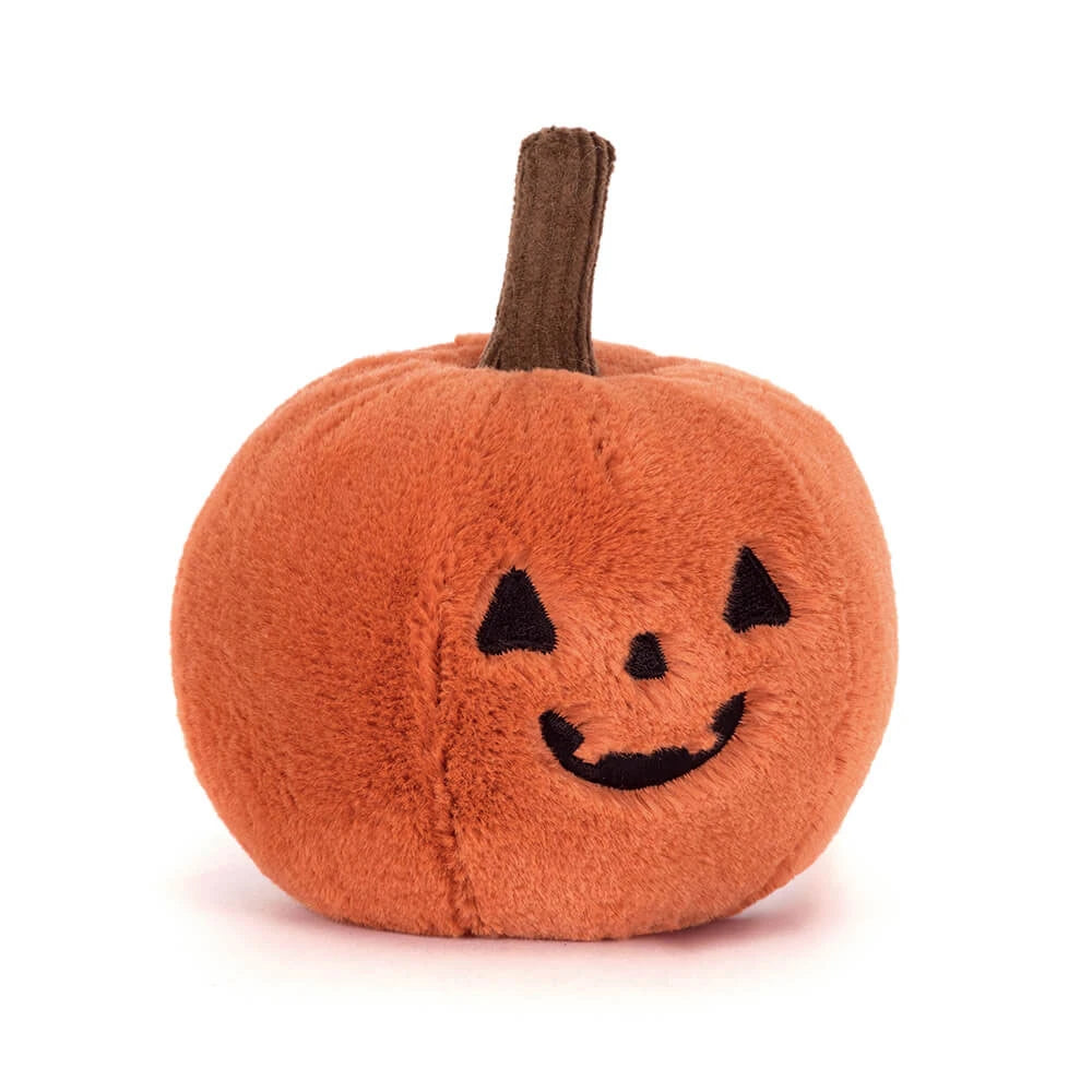Plush pumpkin toy with a smiling face on a white background