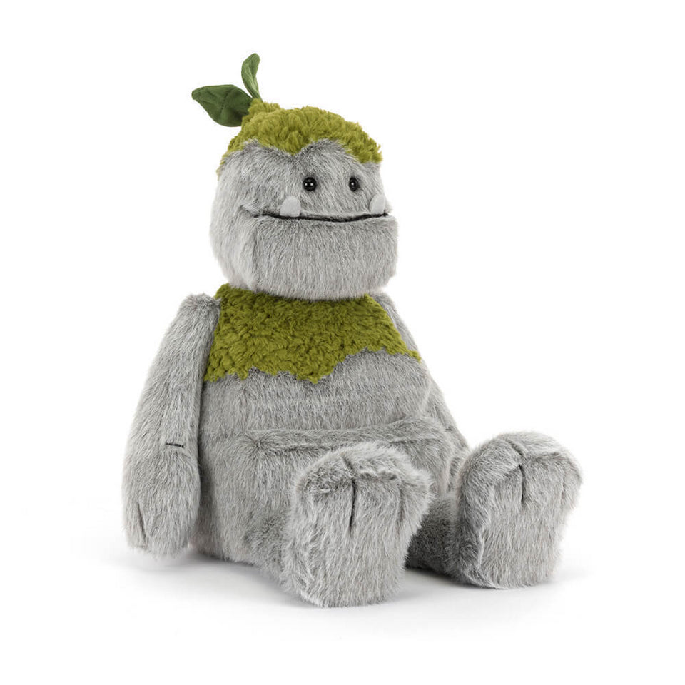 Plush toy resembling a creature with a green top moss on a white background