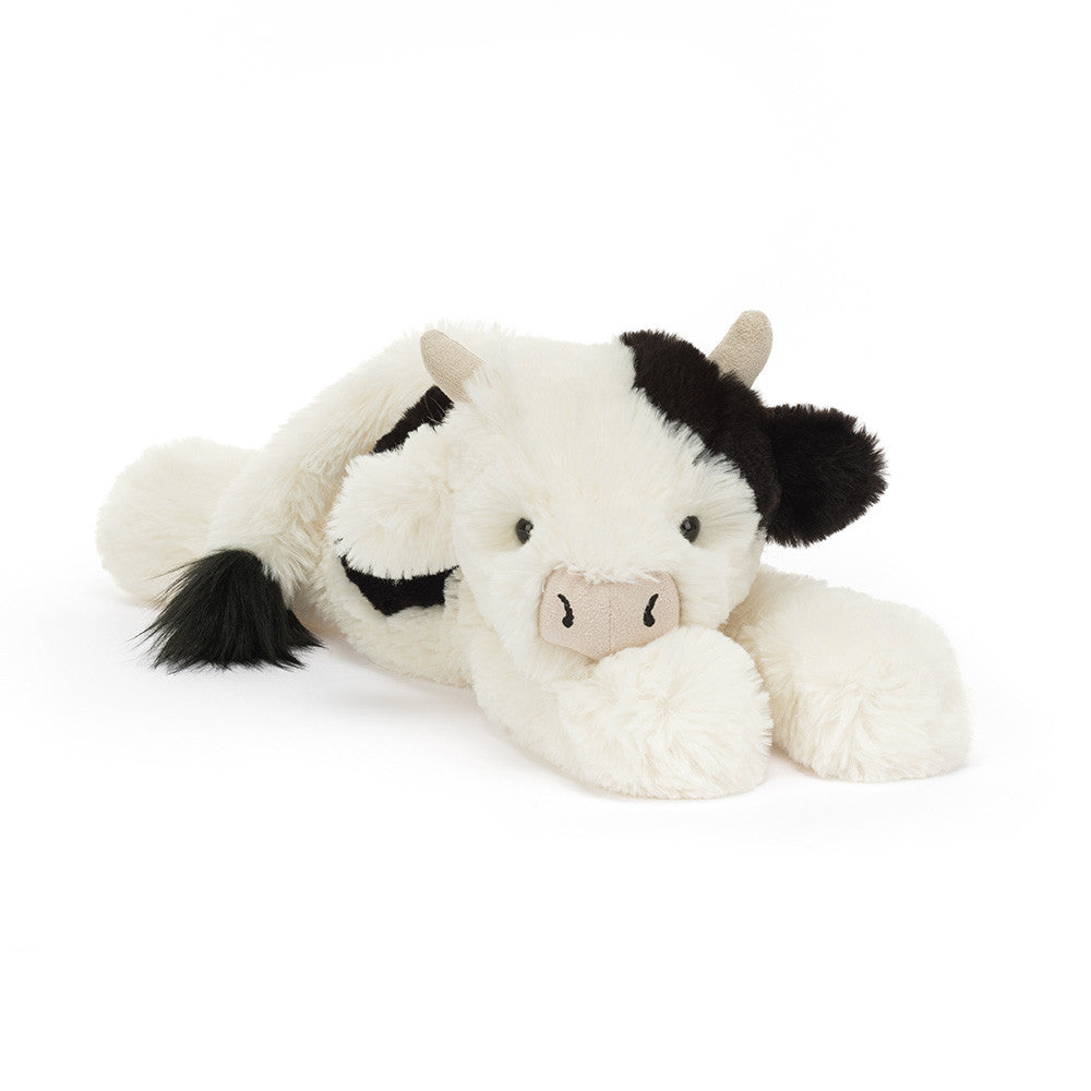 Plush cow toy with black accents on a white background