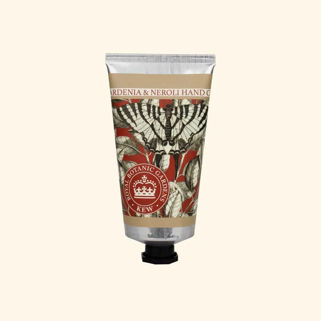 Hand cream tube with decorative label on a beige background