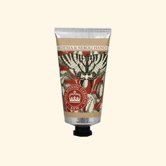Hand cream tube with decorative label on a beige background